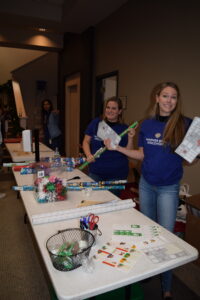 Two of our volunteers from Warner Brothers are ready to gift wrap as they hold up their supplies in this photo! 